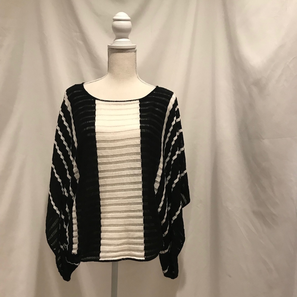 ONE A lightweight knit poncho. One size